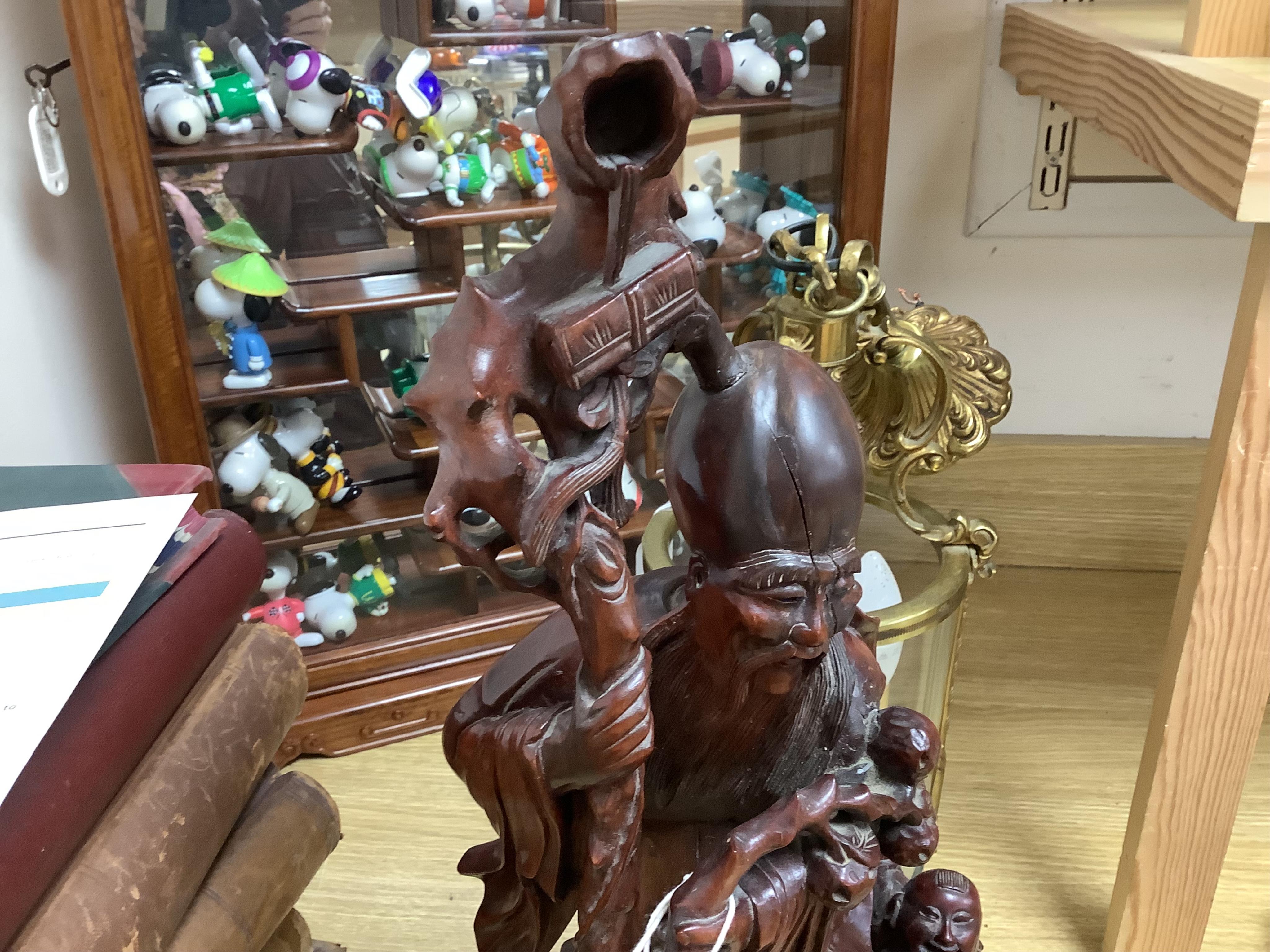 A large Chinese carved wood figure of Shouloau, 51cm high. Condition - some cracks to the wood